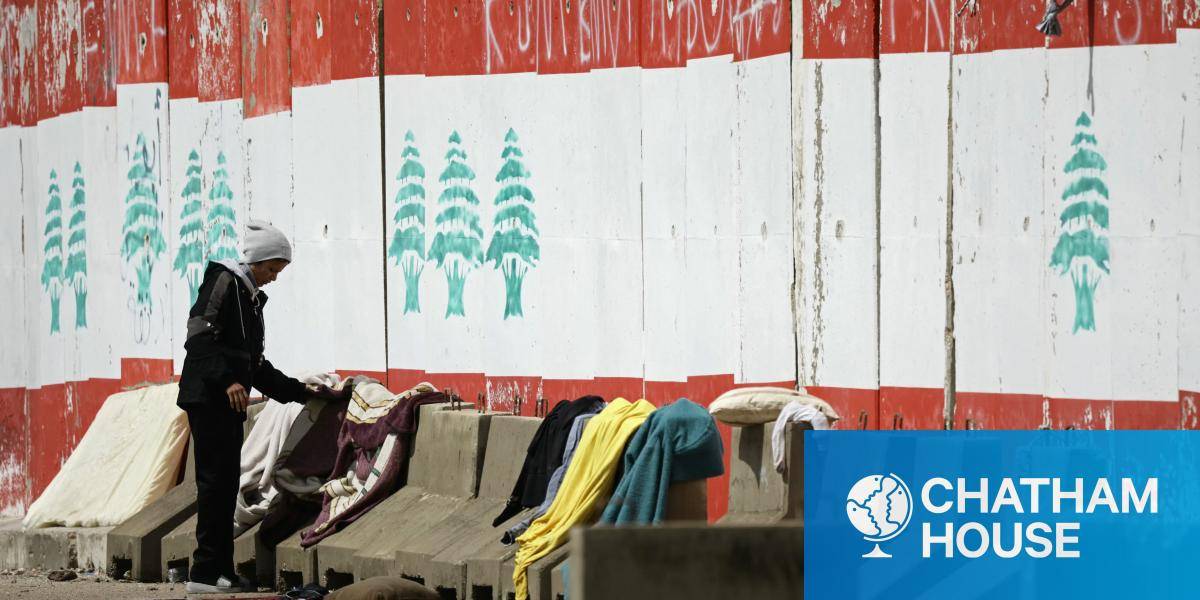 A displaced person puts laundry on concrete blocks at a parking lot in Beirut's waterfront area on 22 March 2026.