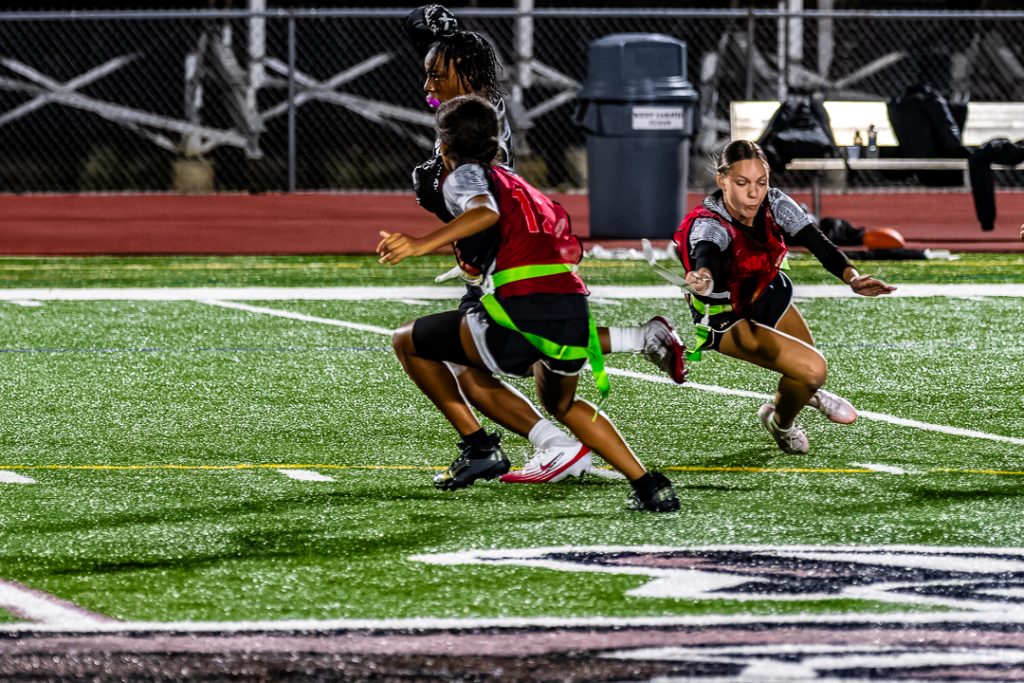 Ursuline freshman Summer Lake makes a diving play to pull the flag off the Caravel runner.