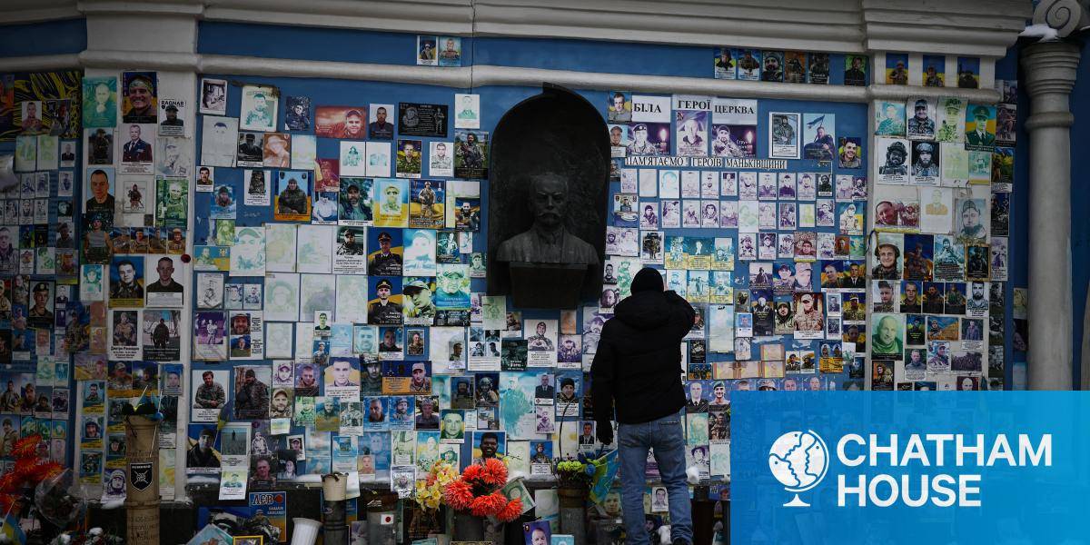 A person stands at The Wall of Remembrance of the Fallen for Ukraine in Kyiv.