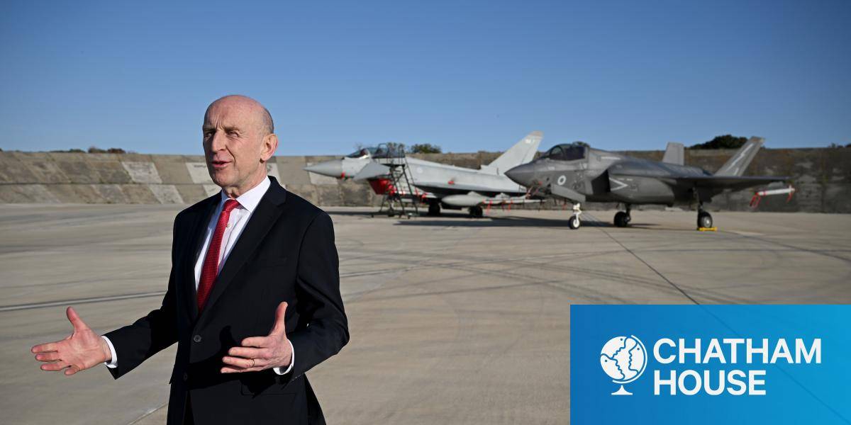 UK Defence Secretary John Healey talks to media at RAF Akrotiri on 5 March 2026 in Akrotiri, Cyprus - two fast jets are parked behind him.