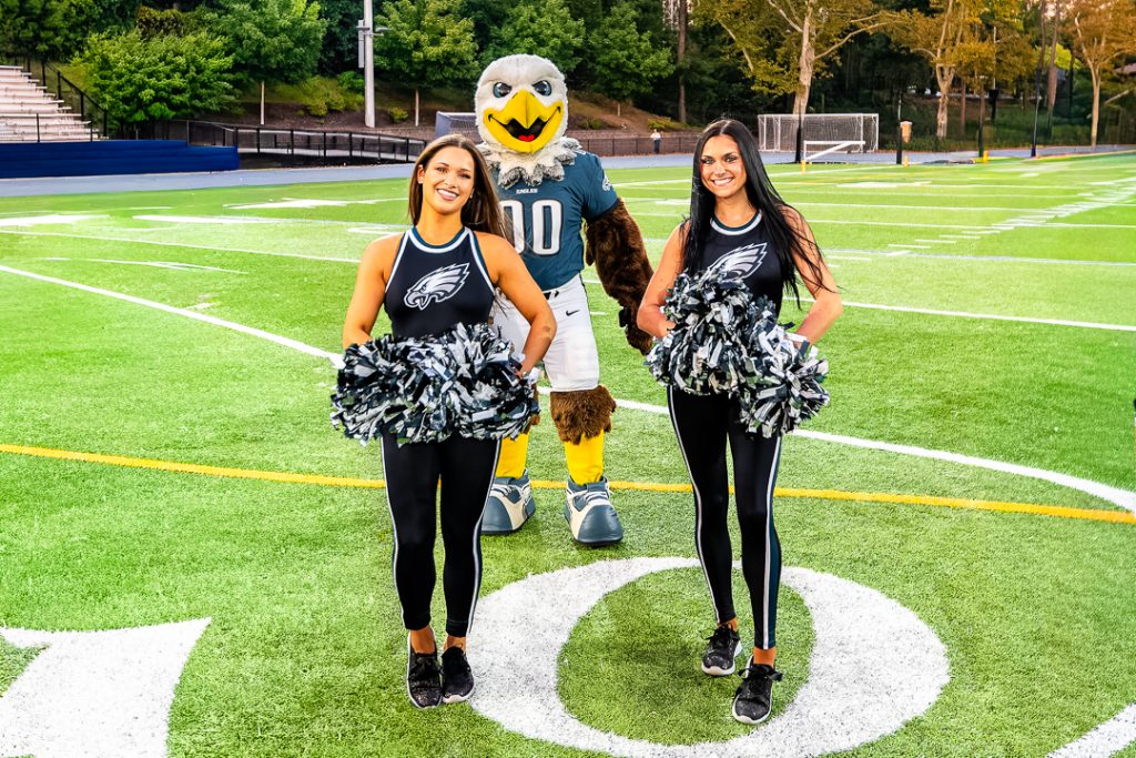 Swoop and a pair of Eagles cheerleaders stand at midfield. The Eagles celebrated their Friday Night Captains Program that helps promote and celebrate local high school football.