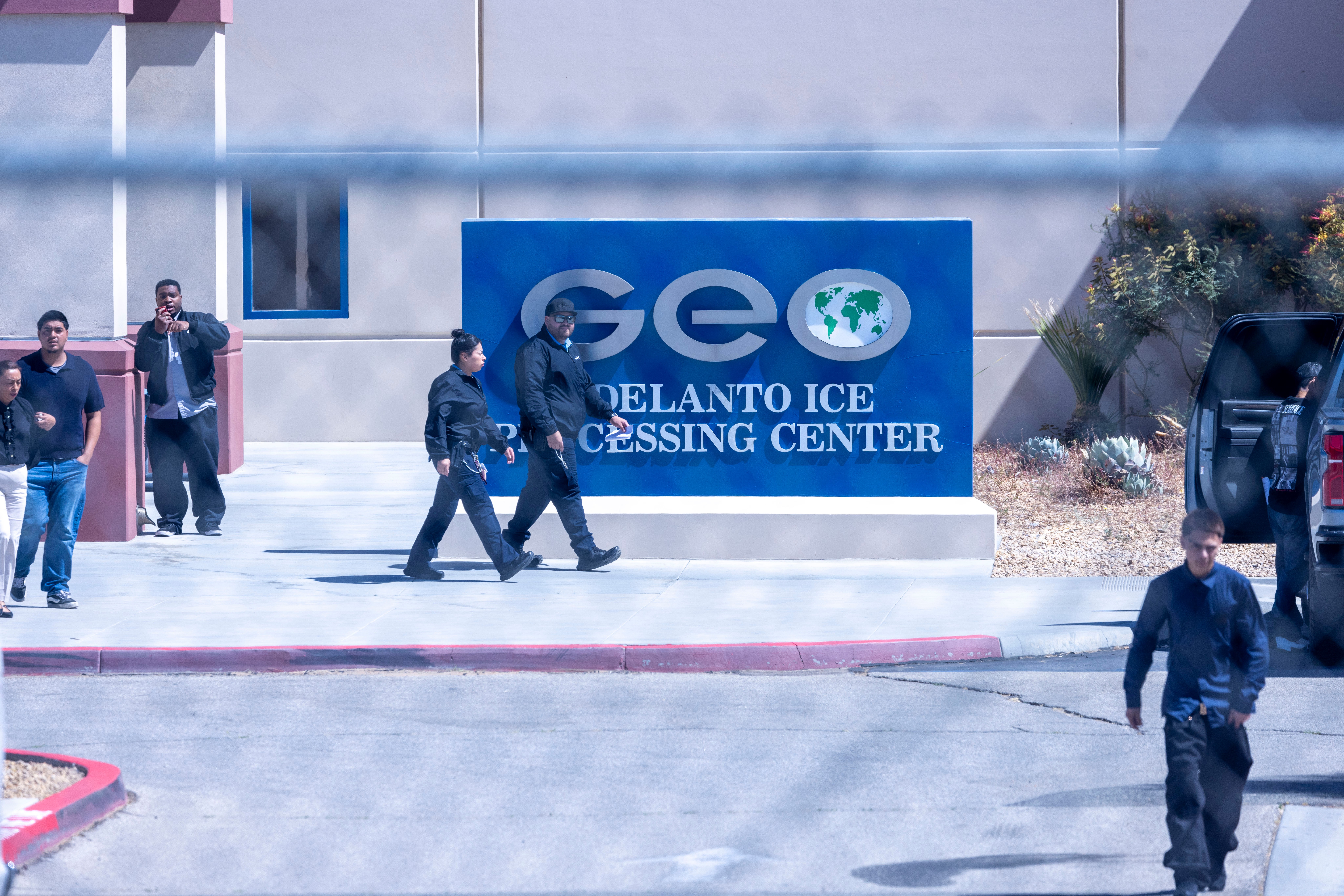 People walk in the parking lot outside the Adelanto ICE Processing Center, Wednesday, May 27, 2026, in Adelanto, Calif. (AP Photo/Jill Connelly)
