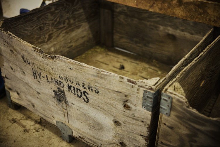 Empty bins made of weathered and battered wood.
