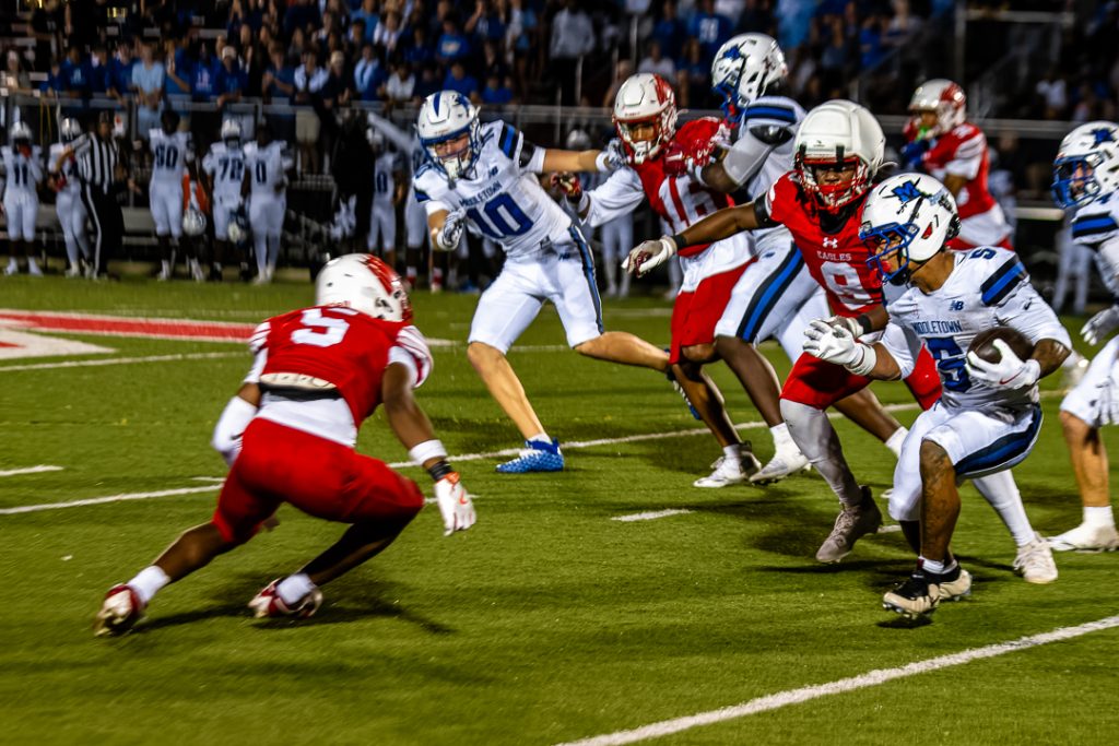 Middletown senior, Hanif Miller, breaks a Smyrna tackle and runs downfield.