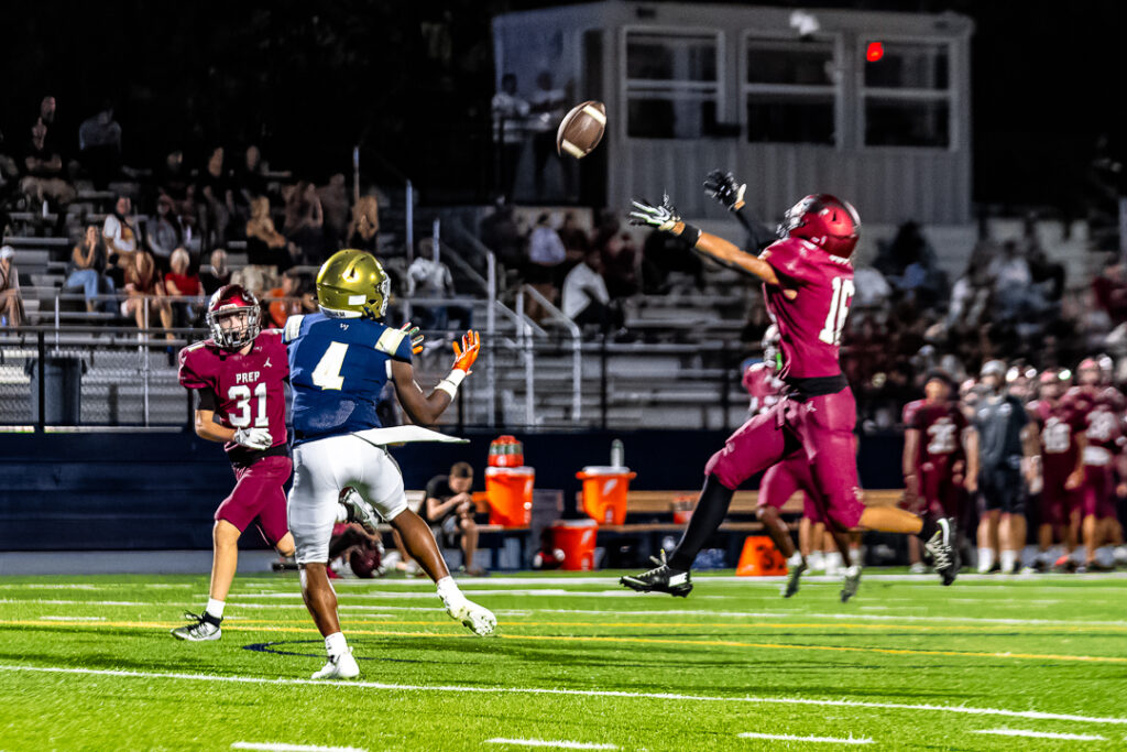 Senior Tysir Jones catches the pass behind the Hawk defenders.
