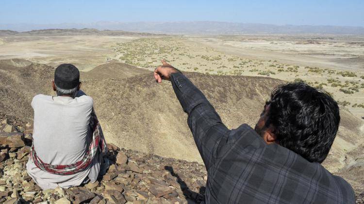 A local resident shows a mountain at the Koh-e-Sabz area of Pakistan's south-west Baluchistan province where Iran launched an airstrike, on 18 January 2024.