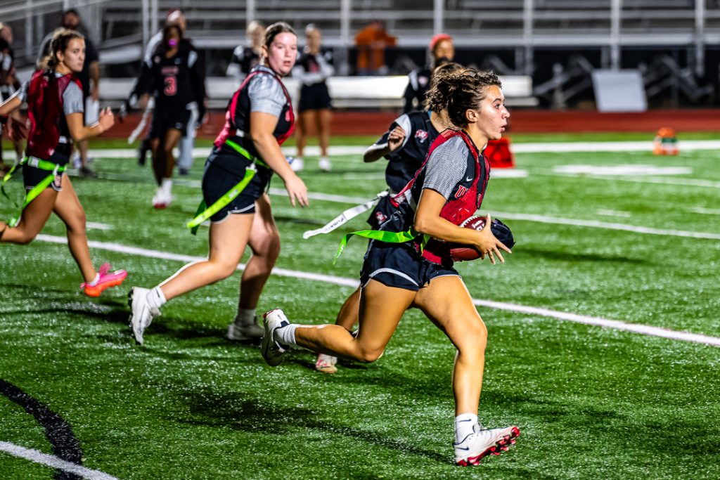 Raider sophomore Delaney Loyola takes a direct snap and runs down the right sideline.