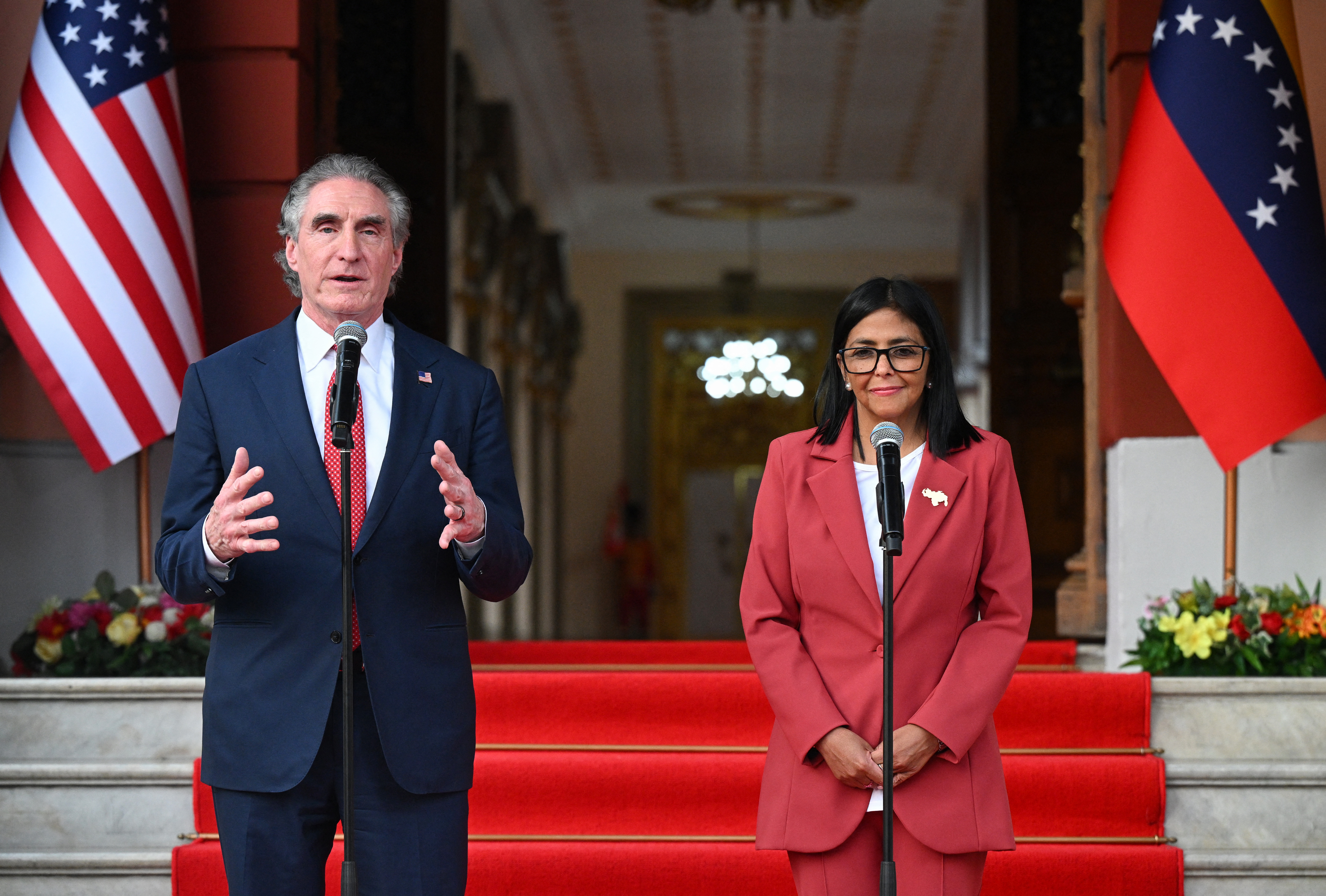US Interior Secretary Doug Burgum speaks alongside Venezuela's interim president, Delcy Rodriguez, after their meeting at the Miraflores Presidential Palace in Caracas on March 4, 2026. US Interior Secretary Doug Burgum on March 4, 2026,  became the latest senior Trump administration official to visit Venezuela, as Washington pushes to ramp up oil and mineral production in the country. (Photo by Federico PARRA / AFP via Getty Images)