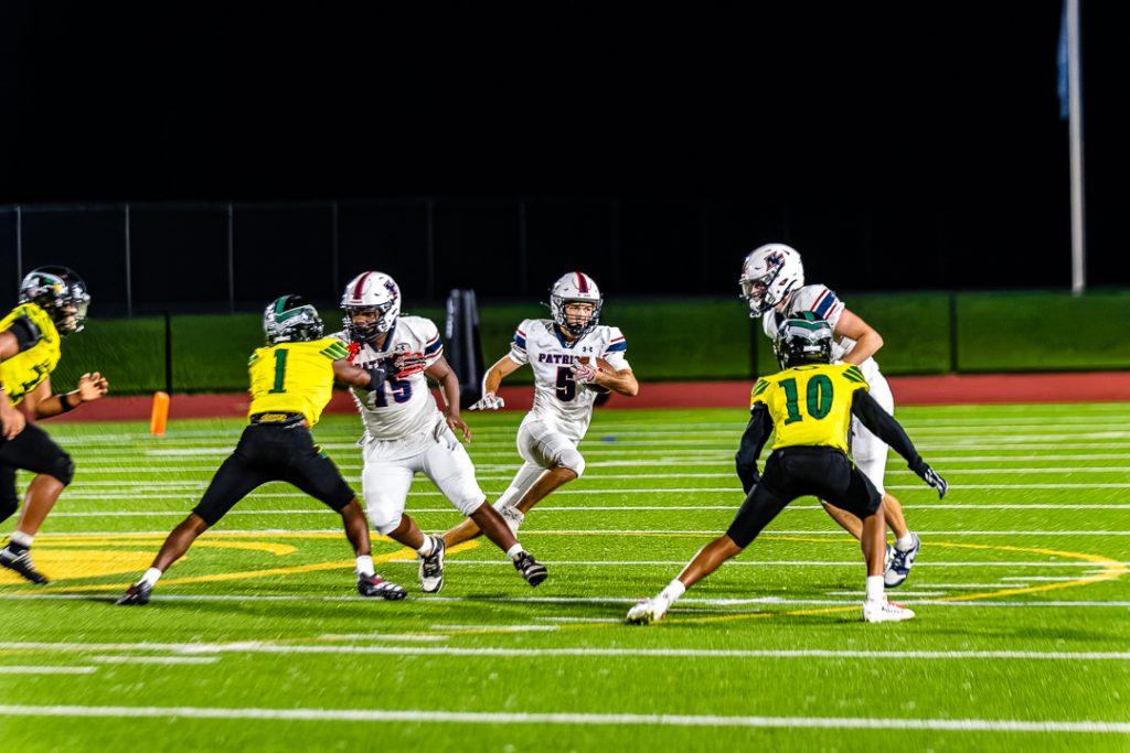 Patriot senior Maxwell Laznik watches as his teammates set up their blocks, choosing which running lane to take.