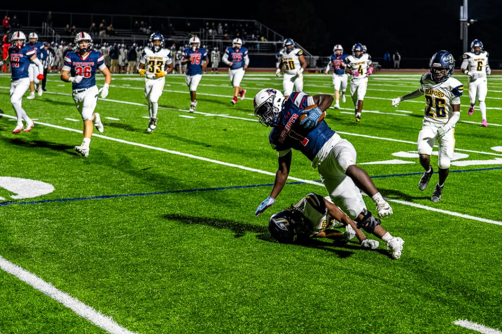 Gbadegbe is brought down by Blue Jay junior Sincere Harris.