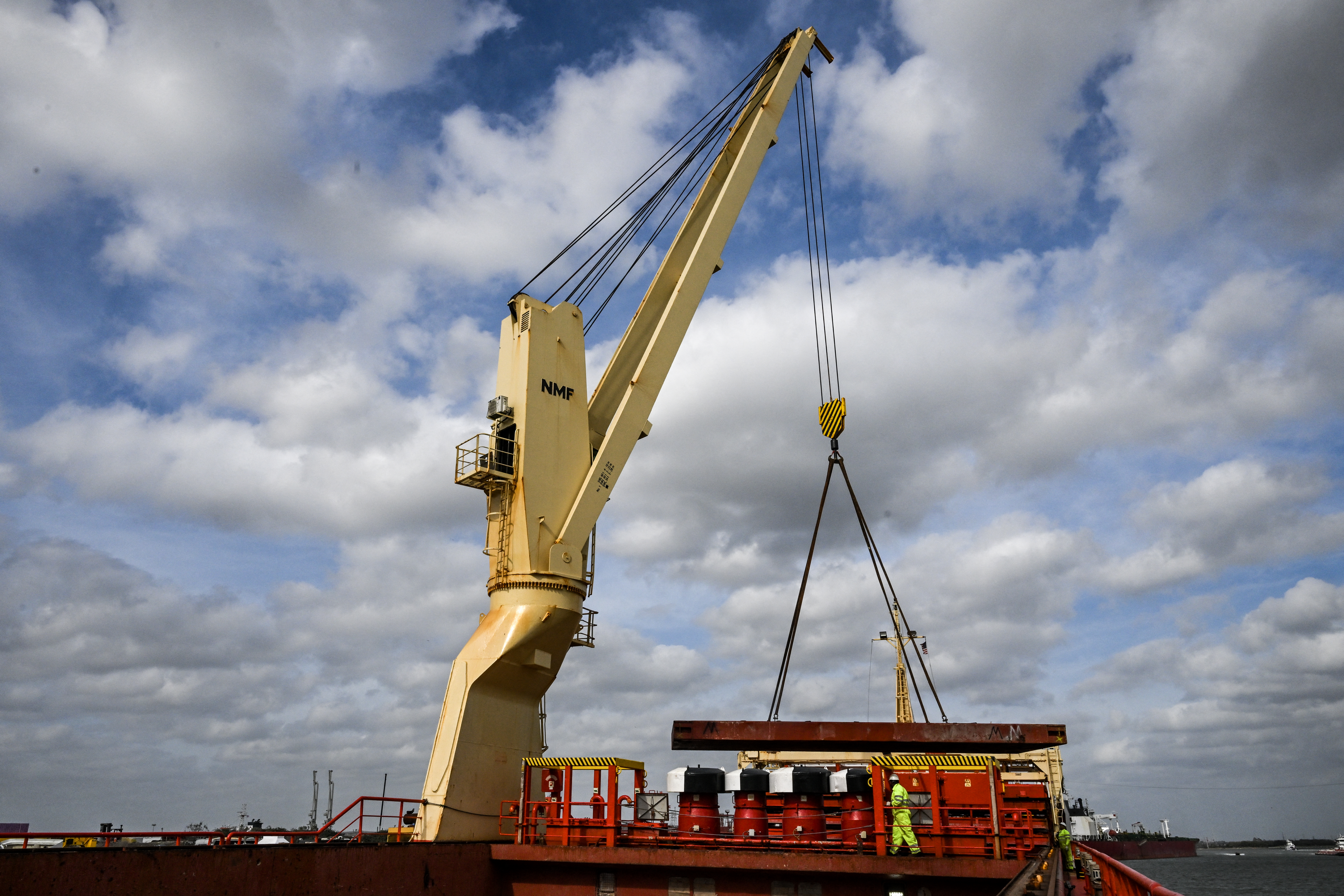 A worker is seen on the Roibeira, sailing under the Portuguese flag, as it is loaded by International Frontier Forwarders, Inc. with equipment for the oil and gas industry bound for Venezuela at the Port of Houston, Texas on February 25, 2026. Workers in hard hats teem aboard a cargo ship at the Port of Houston, the latest US ship headed to Venezuela after President Donald Trump lifted restrictions to boost oil production in the crisis-hit country. US sanctions have crippled Venezuela for years, but Trump's administration has been working with interim president Delcy Rodriguez after toppling autocratic leader Nicolas Maduro. Washington has used a carrot-and-stick approach with Rodriguez, praising her for welcoming US oil companies but at the same time threatening her with violence if she does not cooperate. (Photo by RONALDO SCHEMIDT / AFP via Getty Images)