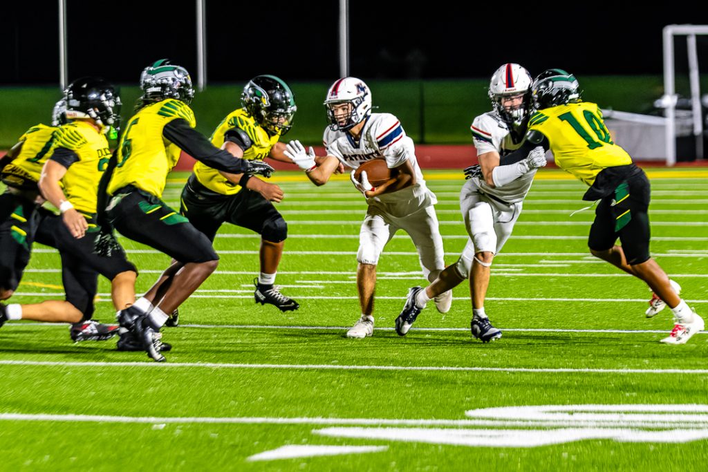 Patriot senior Maxwell Laznik finds a small window of running room against the Odessa defense.