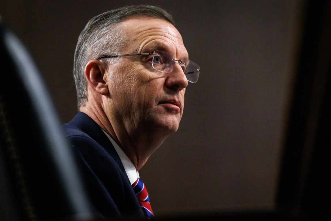 A man wearing glasses and a red and blue tie.