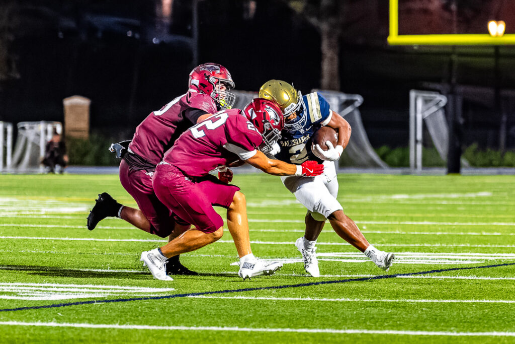 Cotton powers through a pair of St. Joseph defenders to complete his run.