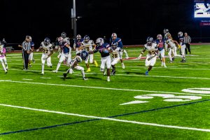 Gbadegbe breaks a tackle during his 43-yard touchdown run following the fumble recovery. The Patriots led, 20-0, late in the first quarter.