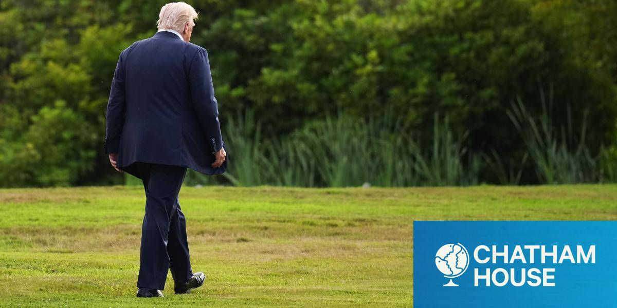 President Donald Trump walks alone to a helicopter