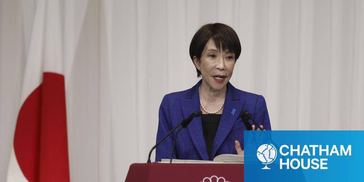 Prime Minister Sanae Takaichi speaks during a press conference next to a Japanese flag