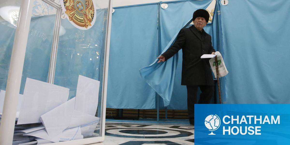 A man leaves a voting booth to cast his ballot at a polling station during the constitutional referendum.