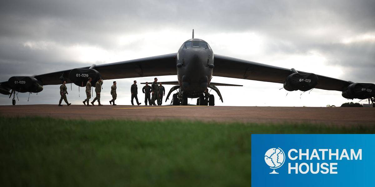 Flight crew walk towards a B-52 Stratofortress bomber aircraft at RAF Fairford on September 19, 2025.