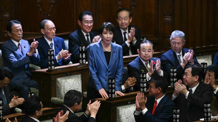 Sanae Takaichi stands up to acknowledge the applause after she was selected as Japan's new prime minister in Tokyo on 21 October, 2025.