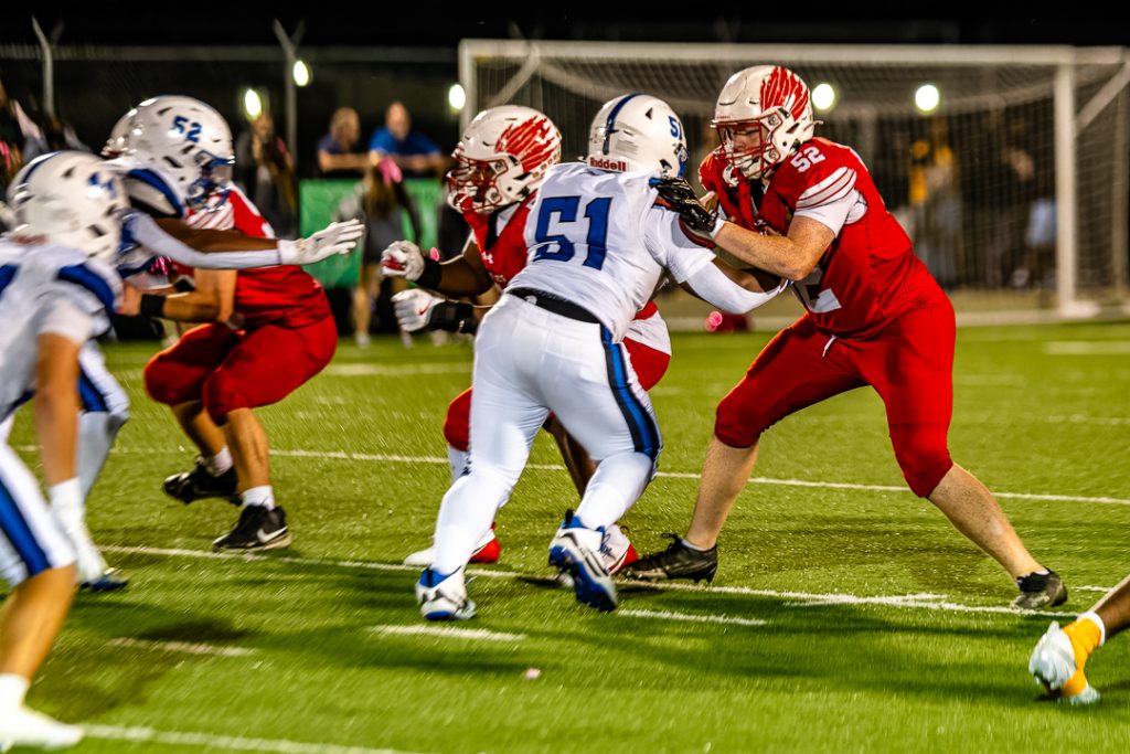 Smyrna's offensive line and Middletown's defensive line battle it out at the line of scrimmage.