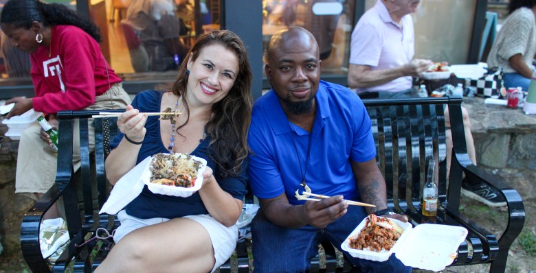 Two people enjoy food at the Delaware Korean Festival