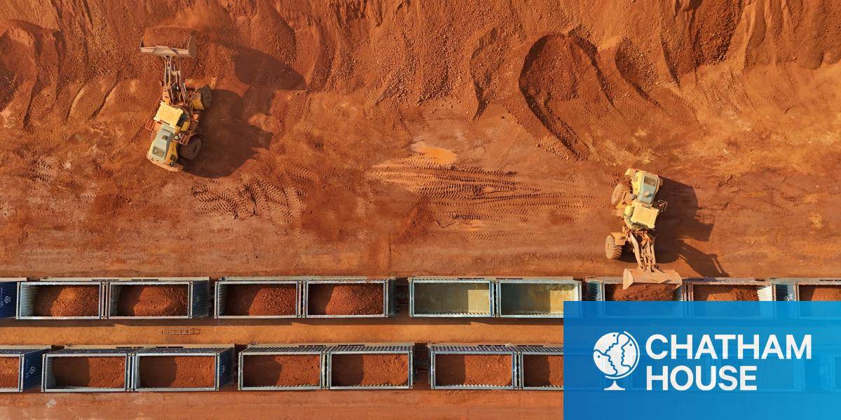 A birds eye view of Yellow vehicles loading minerals onto train compartments