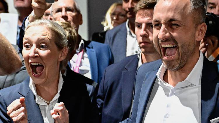 AfD's main candidate in the Saxony-Anhalt state election, Ulrich Siegmund, and the co-leader of the far-right Alternative for Germany (AfD) party Alice Weidel celebrate, a crowd behind them