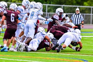 Cape Henlopen senior Jameson Tingle recovers a fumble for the Vikings in their win over Hodgson. Photo Credit: Dave Reeder.