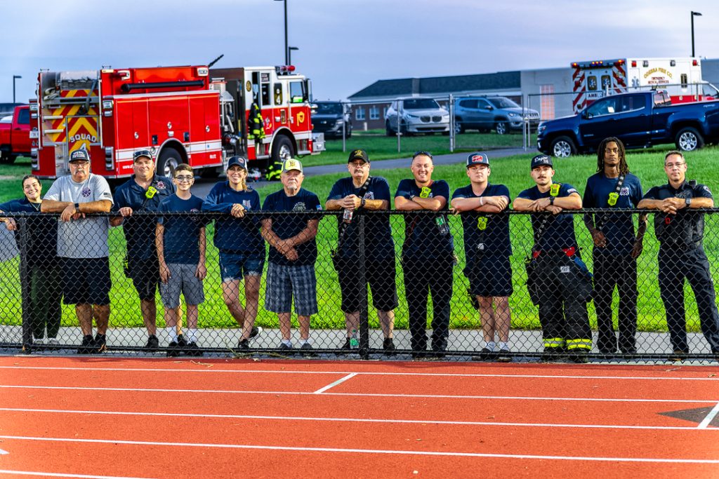 First responders stand along the railing watching as Odessa and Newark Charter play on Friday night.