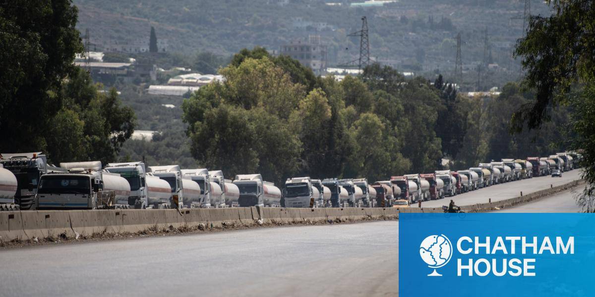 Trucks waiting to offload crude oil onto a tanker ship at the Banyas Oil Terminal in Tartus, Syria