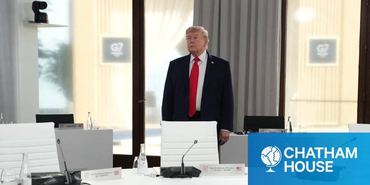 US President Donald Trump stands alone at a G7 conference table