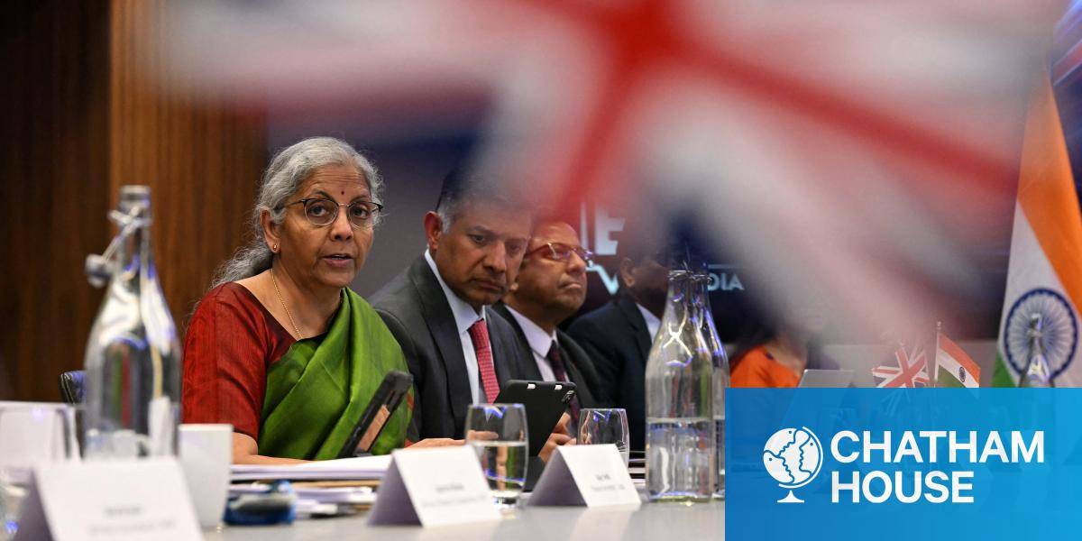 India's Finance Minister Nirmala Sitharaman speaking during a meeting with the UK government, a UK flag prominent in the foreground