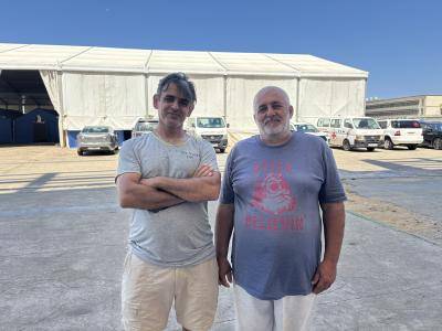 Two men stand outside a refugee shelter in Beirut 