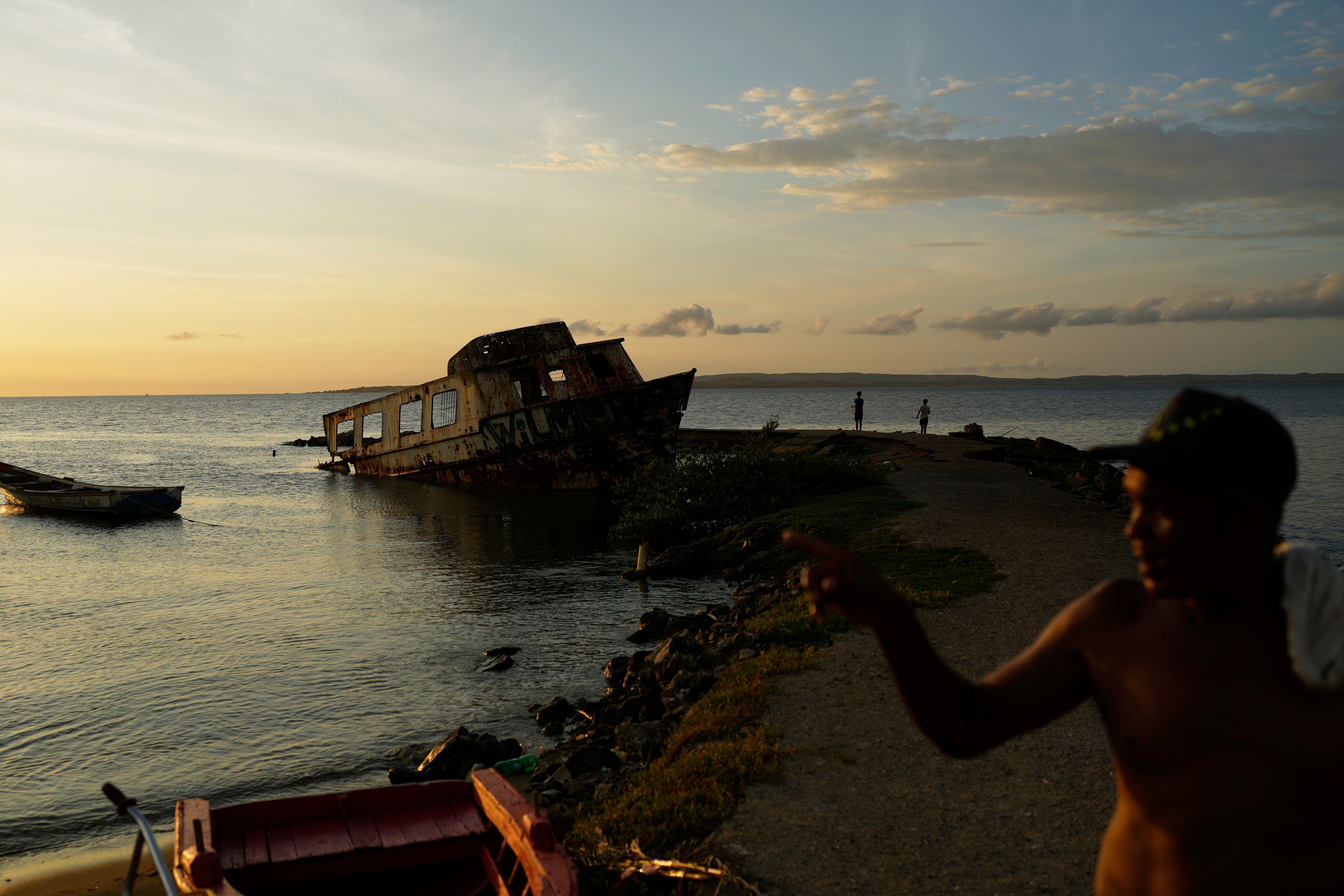 A boat sits stranded along the shore in Cumana, capital of Venezuela's Sucre state, Sept. 12, 2025. (AP Photo/Ariana Cubillos, File)