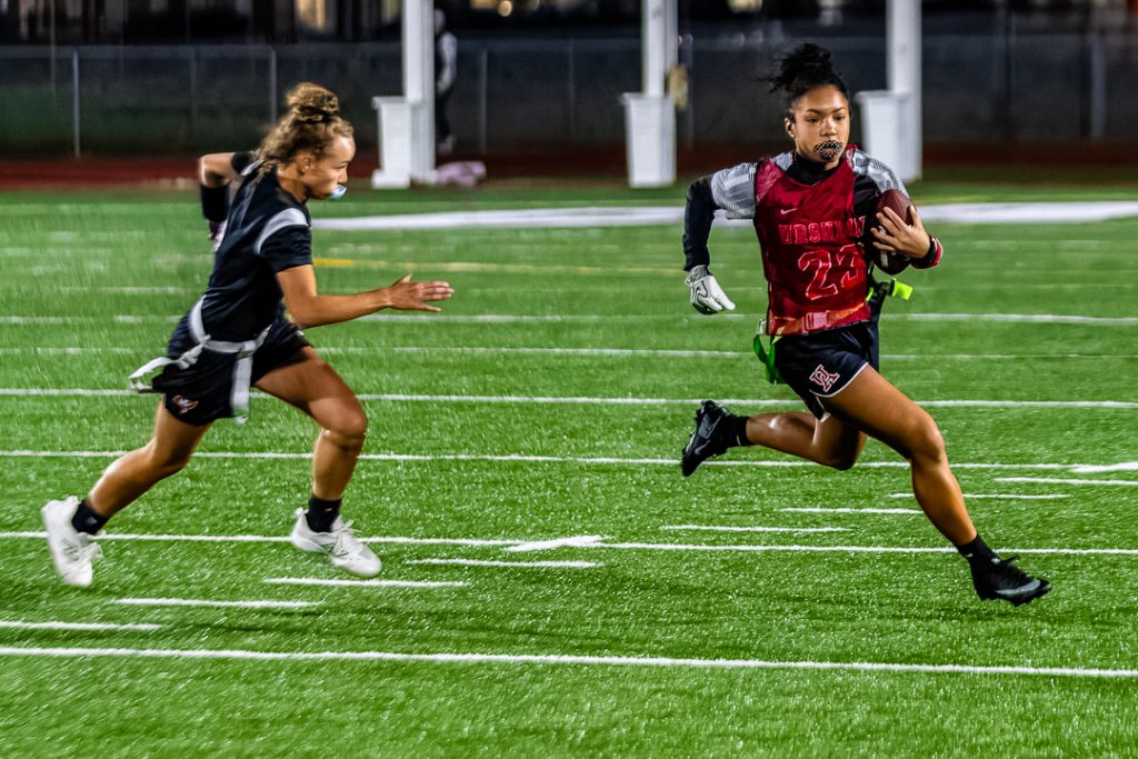 Ursuline freshman Ava Lewis runs toward the left sideline to avoid the Caravel defender.