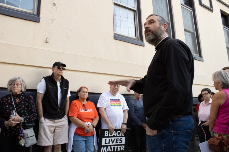 The Rev. Patrick Burke, pastor at The Episcopal Church of Saints Andrew and Matthew in Wilmington speaks to attendees a the Walk for Justice and Peace on Nov. 1, 2024.
