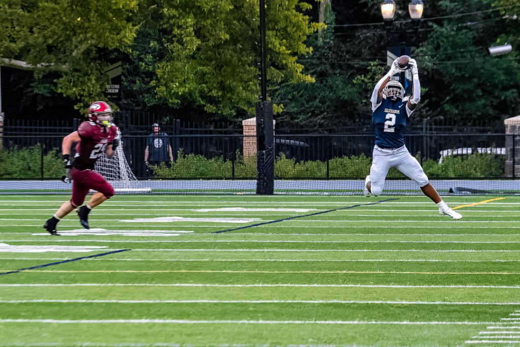 Salesianum Junior EstherVell Cotton leaps into the air to haul in a pass. 