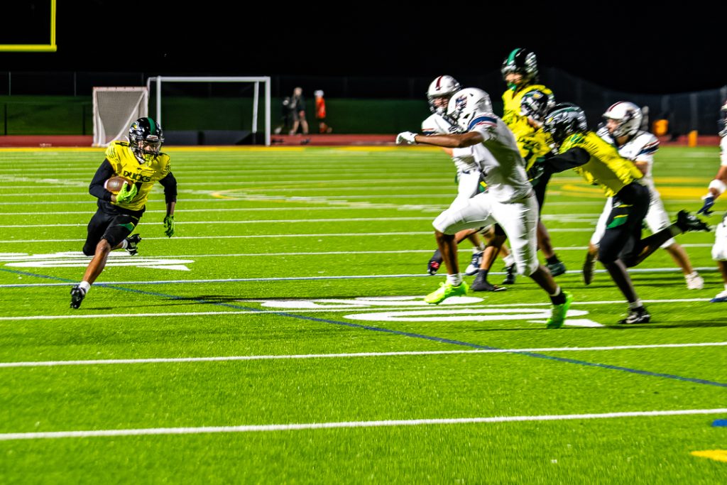 Duck senior Xavier Terrell runs down the right side as the Ducks move toward the endzone.