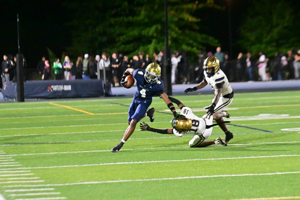 Salesianum senior Tysir Jones evades a defender during his 78-yard reception in Salesianum Football's matchup against La Salle College High School. Photo credit: Dave Reeder.