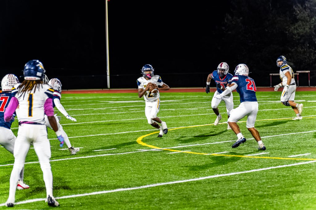 Seaford quarterback Everette Burton moves around in the pocket looking for an open receiver.
