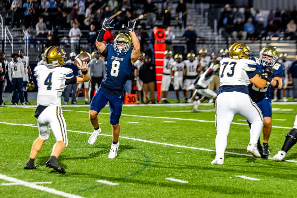 Salesianum defender, Jett Healy, attempts to knock the pass down on La Salle's first offensive possesion.