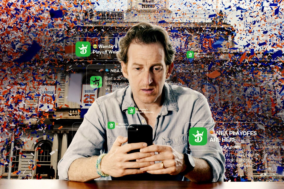A man sits down at a desk staring intently at his phone. Blue and orange confetti rains down behind him. Notifications from DraftKings pop up around him.