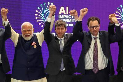 India's prime minister Narendra Modi, left, with OpenAI chief executive Sam Altman, centre, and Anthropic chief executive Dario Amodei at the AI Impact Summit in New Delhi on 19 February, 2026