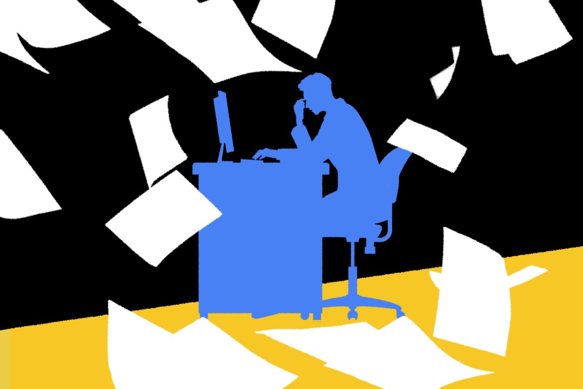 A silhouette of a man at his desk. He has his head in his hand while typing on a computer. He is surrounded by silhouettes of flying papers.