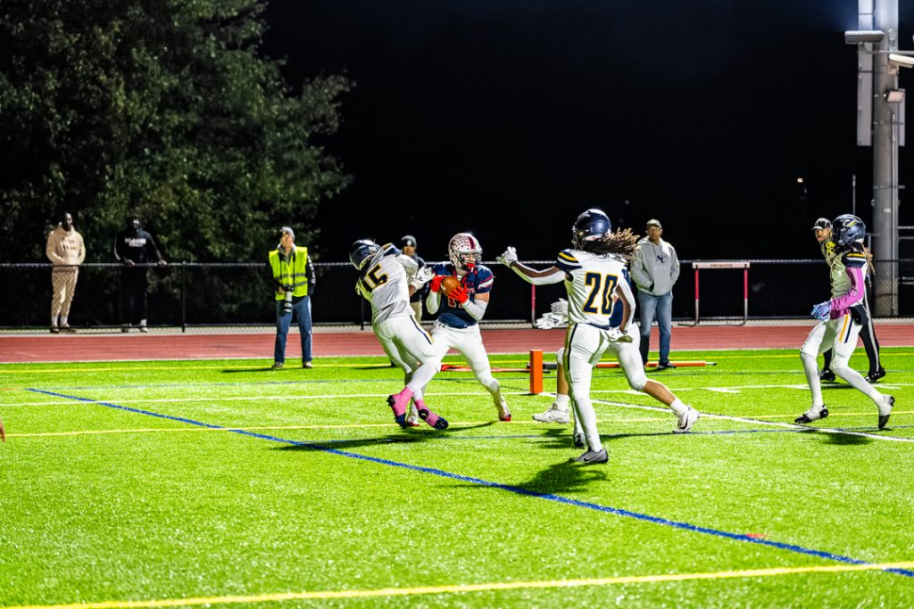 Newark Charter junior Austin Ledoschuk hauls in a nine-yard touchdown pass near the front pylon. Photo Credit: Dave Reeder. 