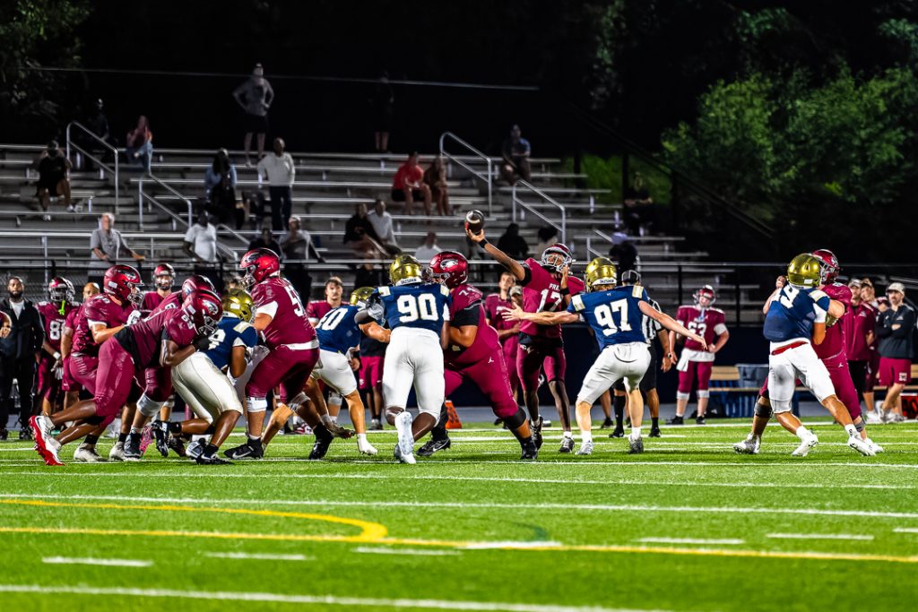 The St. Joseph QB launches a deep pass toward the left sideline.