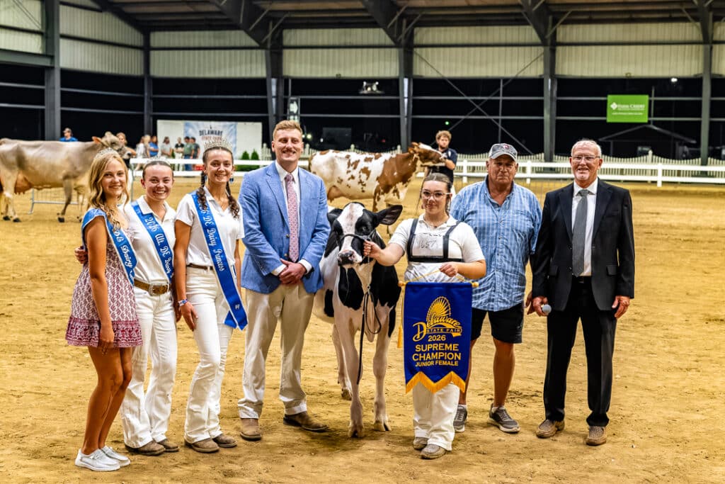The winner of the Supreme Championship Junior Female cow division takes a picture after the Open Dairy Cattle Show.