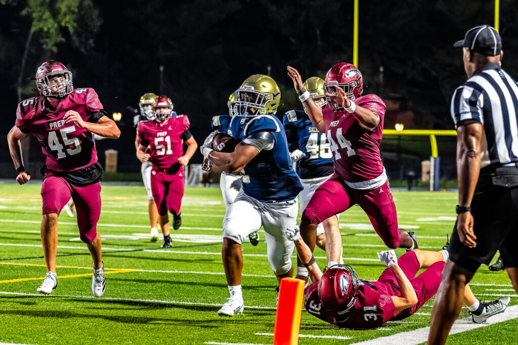 Cotton breaks a Hawk tackle and runs into the endzone for a Sallies touchdown.