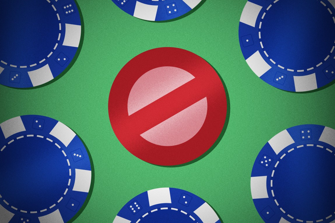 Blue gambling chips surround a red chip in the shape of a “no” symbol, with a slash through the center of the chip.